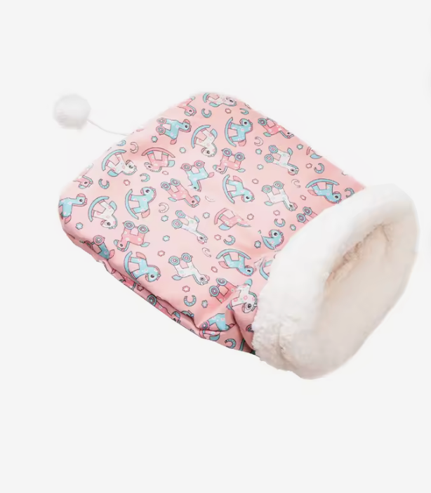 Pink Cozy Cave Cat Bed with rocking-horse print and cream sherpa-lined hood, pom-pom toy attached